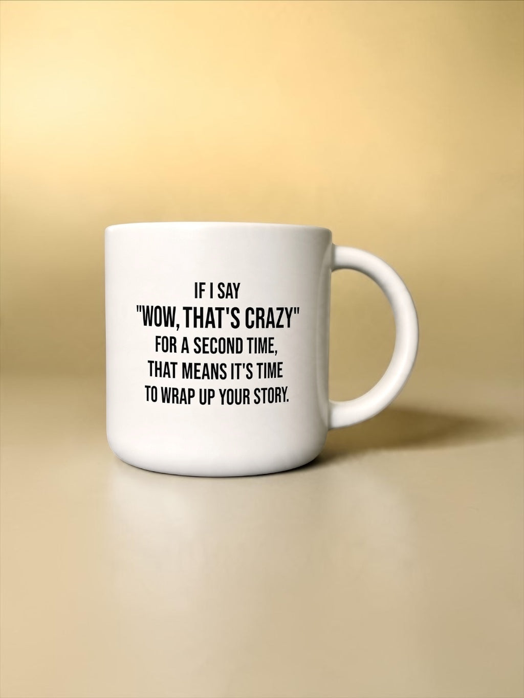 A white ceramic coffee mug with black printed text that reads, 'IF I SAY "WOW, THAT'S CRAZY" FOR A SECOND TIME, THAT MEANS IT'S TIME TO WRAP UP YOUR STORY.' The mug is shown on a warm beige gradient background.