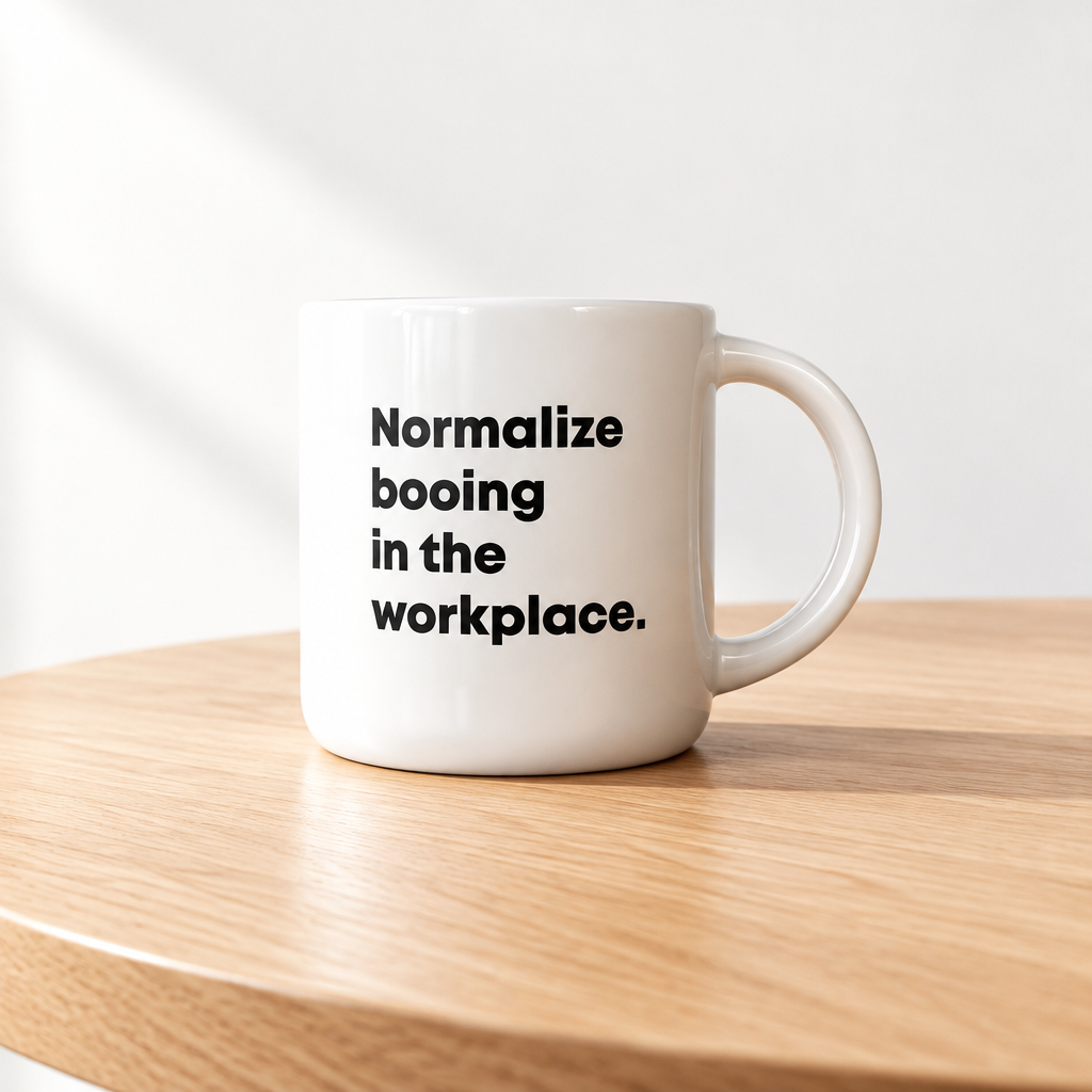 Coffee mug printed with “Normalize booing in the workplace.”