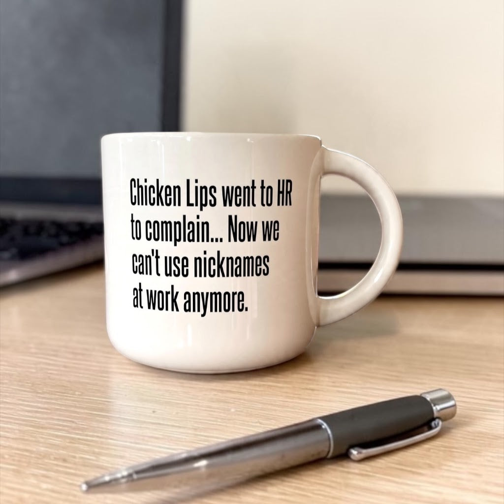 Coffee mug printed with “Chicken Lips went to HR to complain. Now we can't use nicknames at work anymore.”, additional view